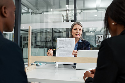 Buy stock photo Shot of a mature businesswoman having a meeting with a sneeze guard in a modern office