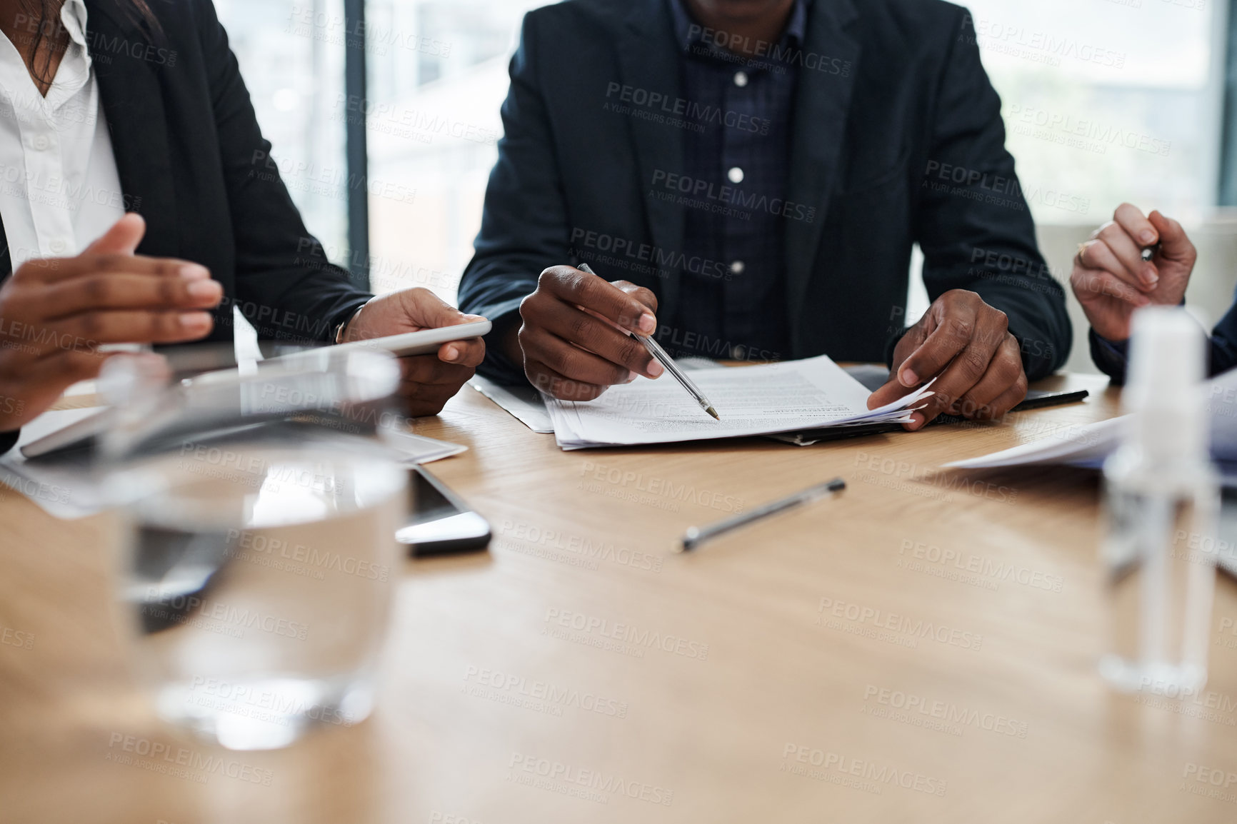 Buy stock photo Shot of a group of unrecognisable businesspeople having a meeting in a modern office