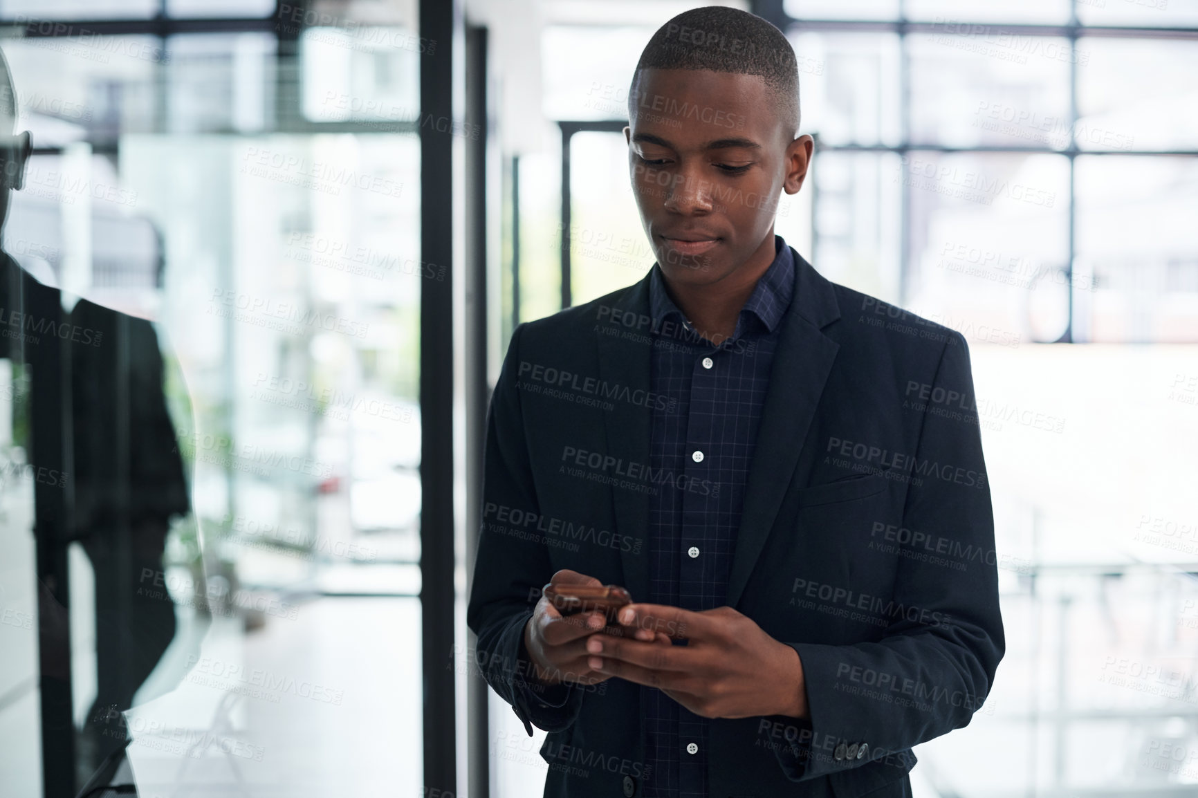 Buy stock photo Businessman, smartphone notification and texting in office for communication, internet news or job post. Black person, mobile tech and typing in workplace for social media and online research