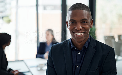 Buy stock photo Shot of a young businessman attending a meeting in a modern office