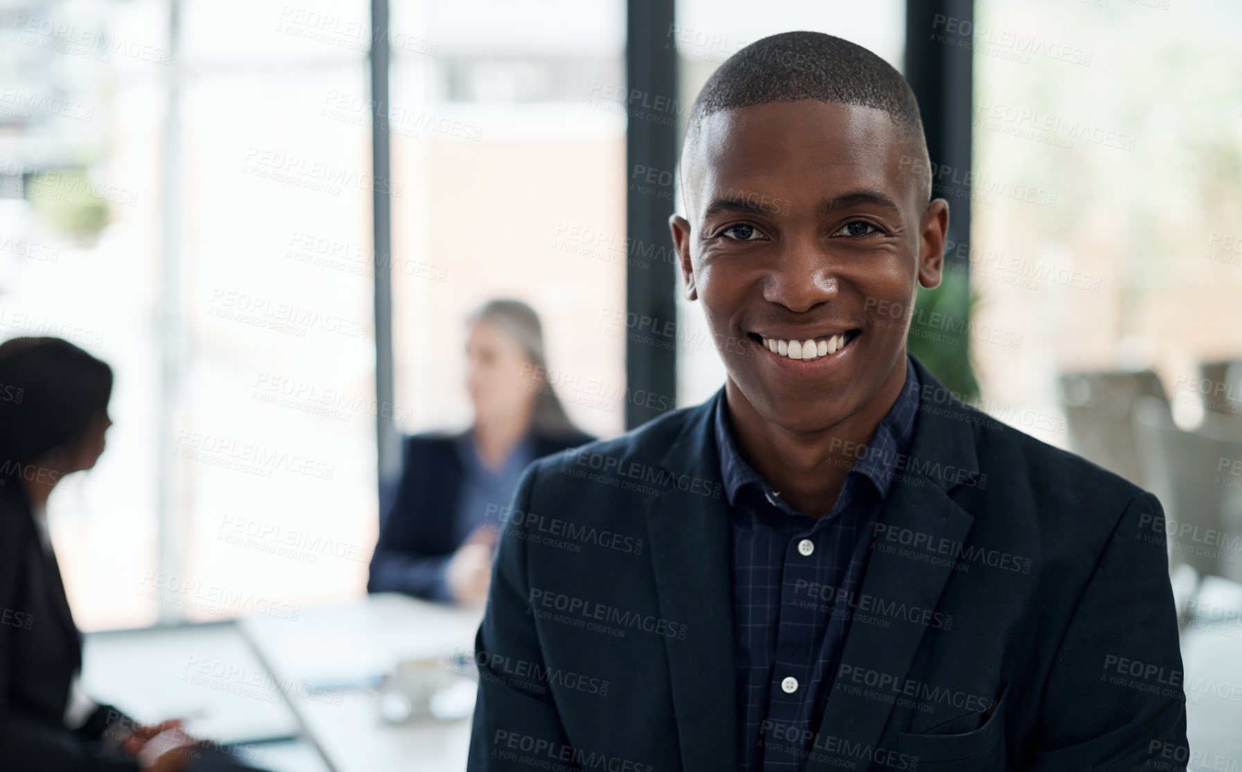 Buy stock photo Shot of a young businessman attending a meeting in a modern office