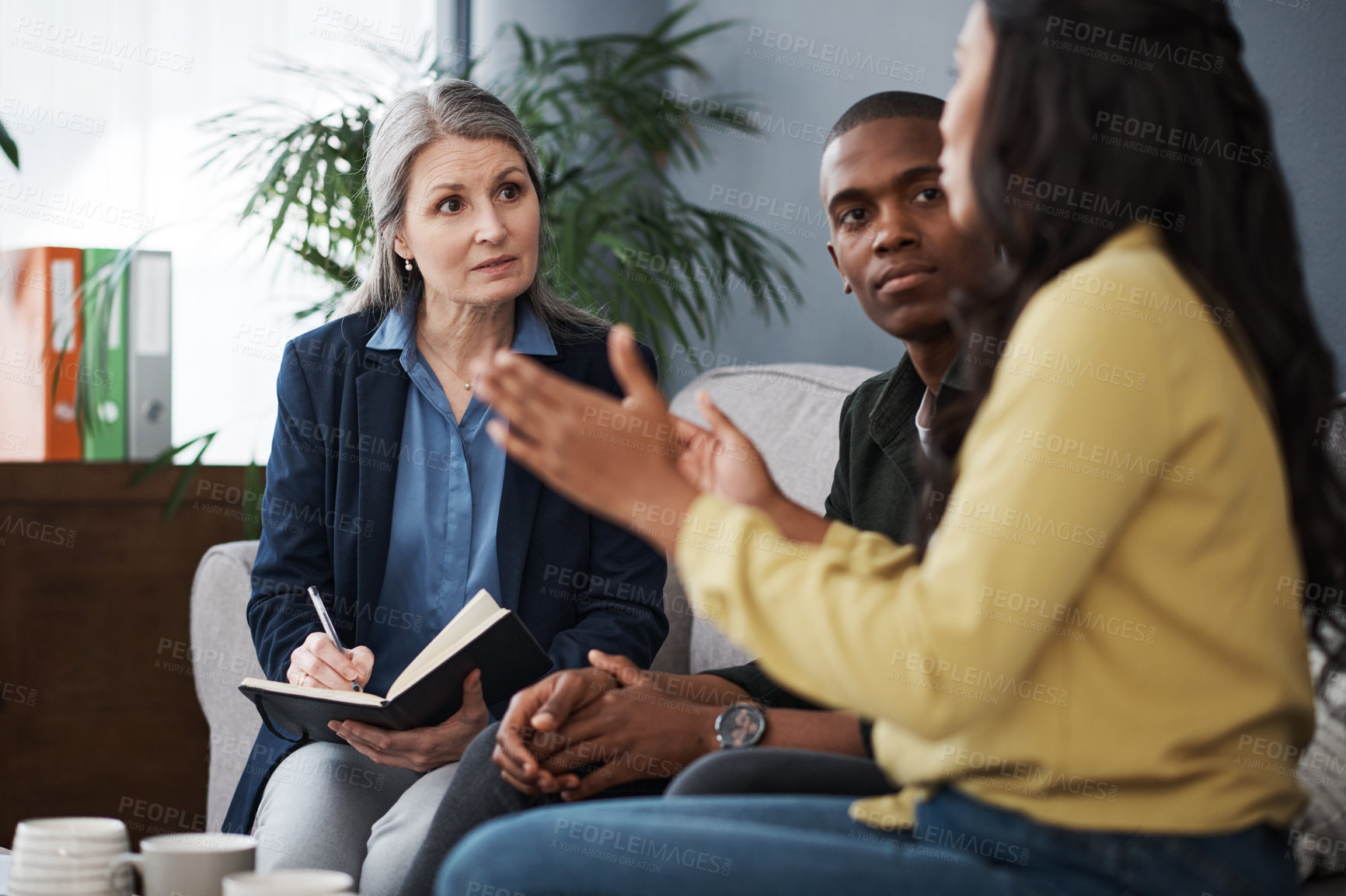 Buy stock photo Shot of a couple speaking to a financial advisor at home