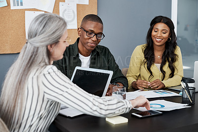 Buy stock photo Shot of a group of businesspeople brainstorming in a modern office
