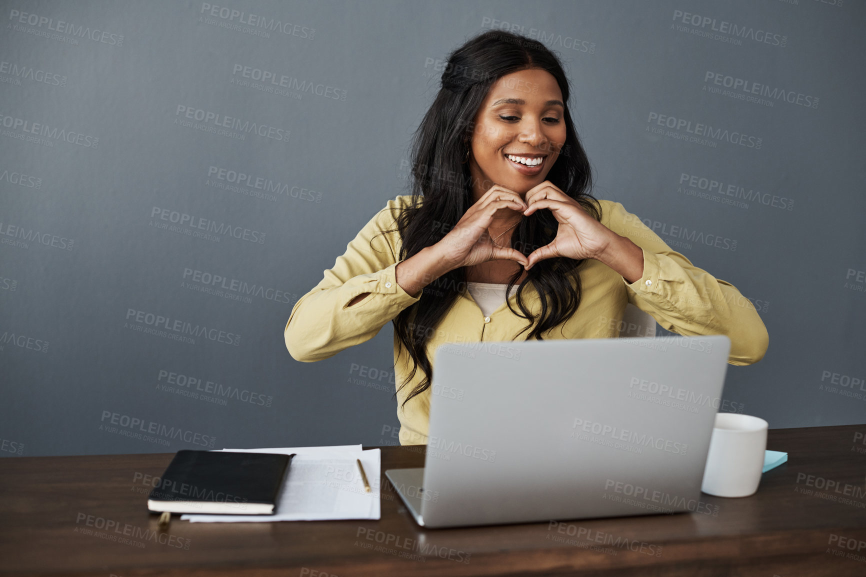 Buy stock photo Woman, laptop and love heart for video call with emoji for networking, communication and internet at desk. Happy, online and technology with female person, conversation and thank you for company 