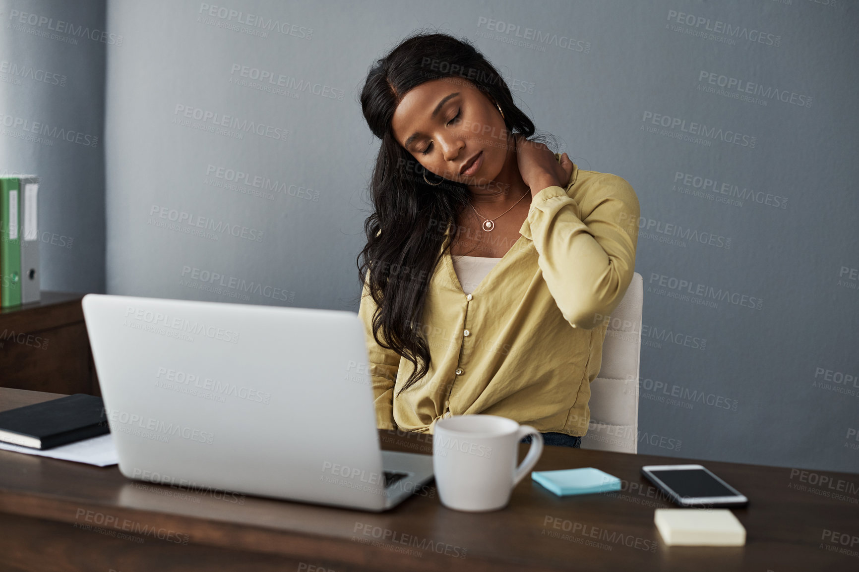 Buy stock photo Young businesswoman experiencing a neck cramp during work