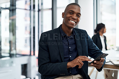 Buy stock photo Shot of a young businessman using a smartphone during a meeting in a modern office