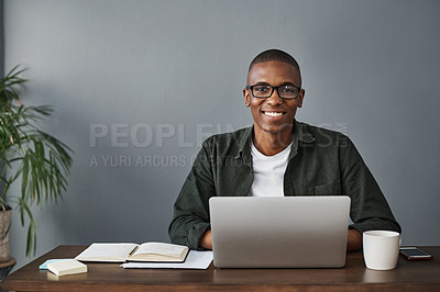 Buy stock photo Shot of a young businessman typing on his laptop