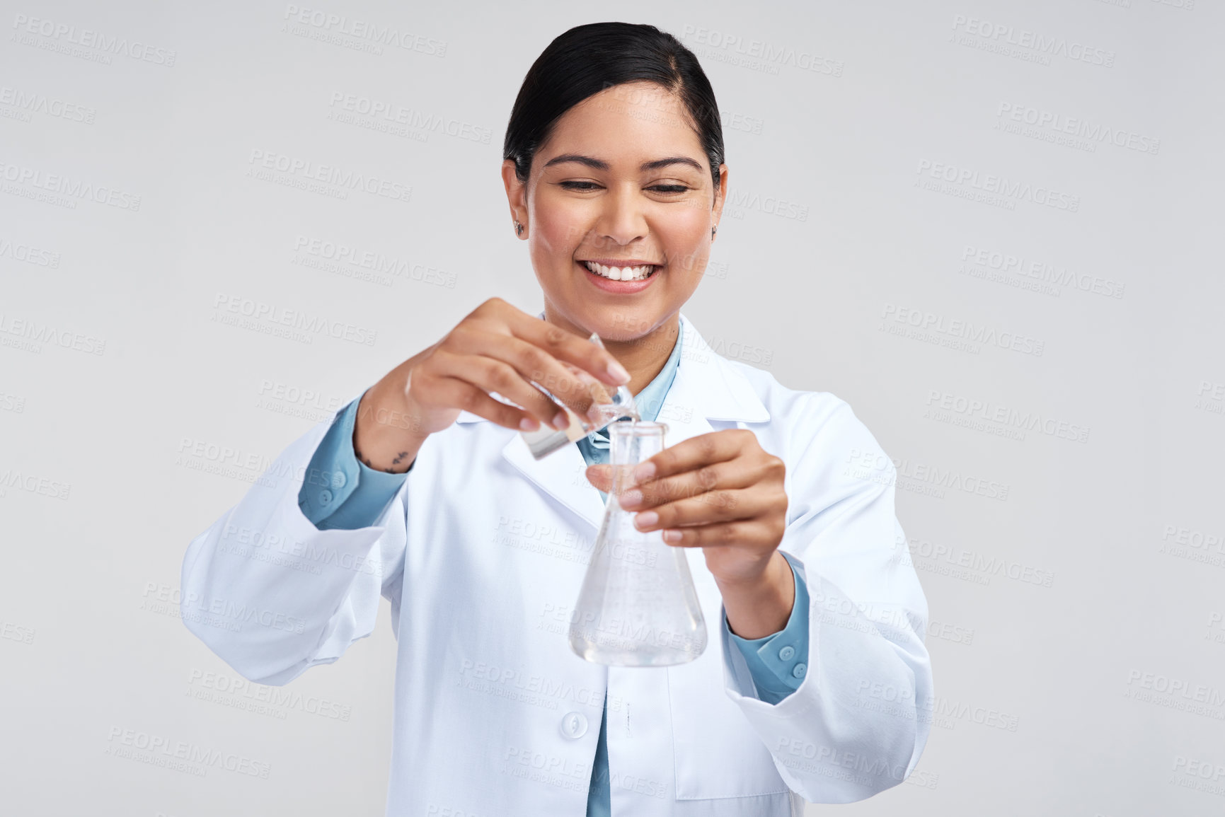 Buy stock photo Cropped shot of an attractive young female scientist mixing samples in studio against a grey background