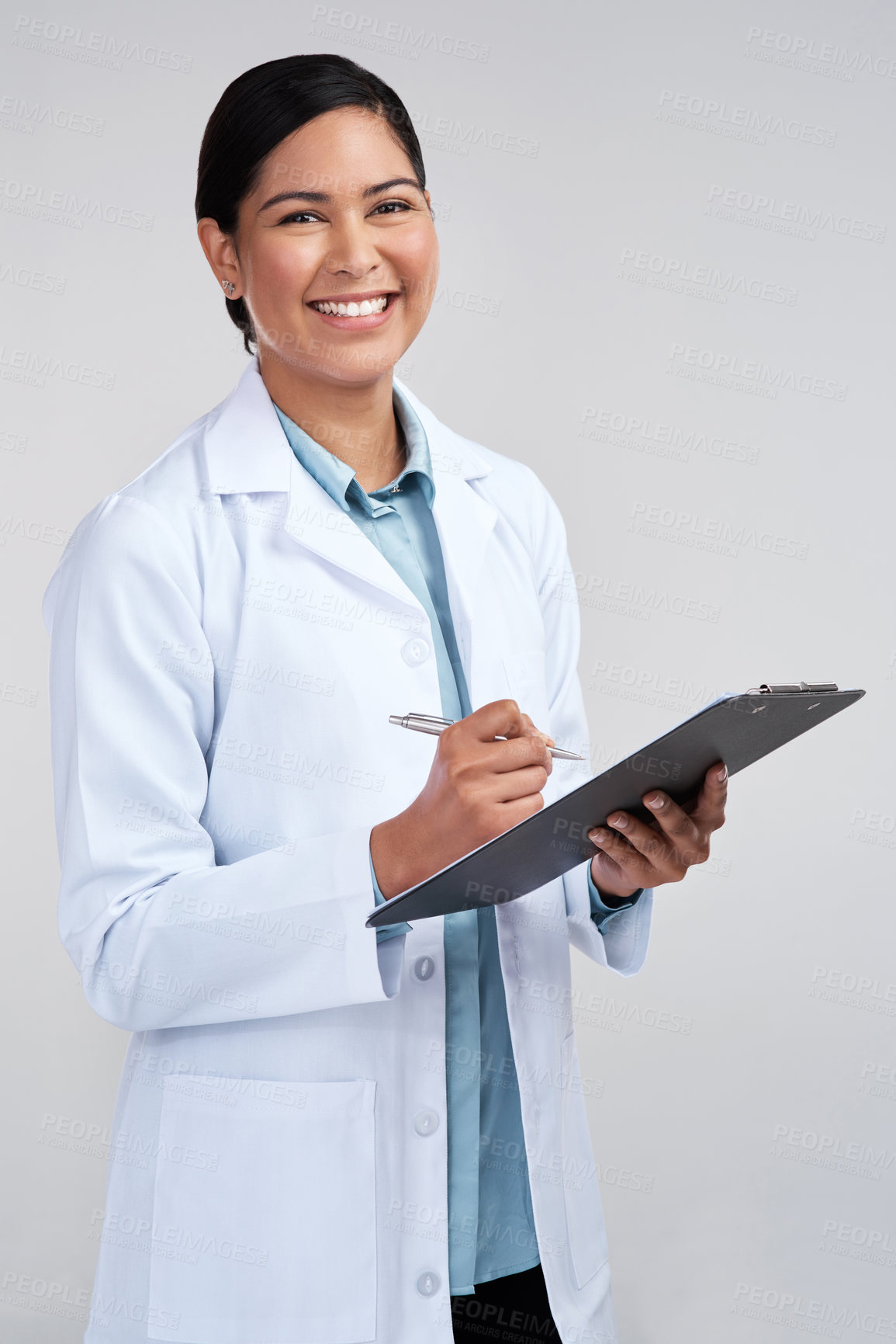 Buy stock photo Cropped portrait of an attractive young female scientist working on a clipboard in studio against a grey background