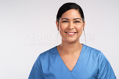 Buy stock photo Portrait of a young beautiful doctor in scrubs against a white background