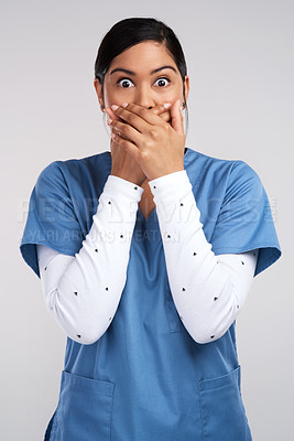 Buy stock photo Portrait of a shocked young doctor in scrubs against a white background
