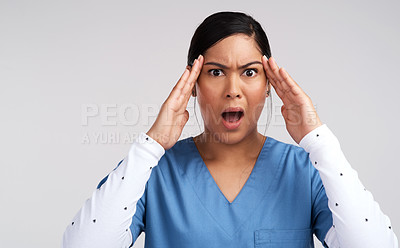 Buy stock photo Portrait of a mind blown young doctor in scrubs against a white background