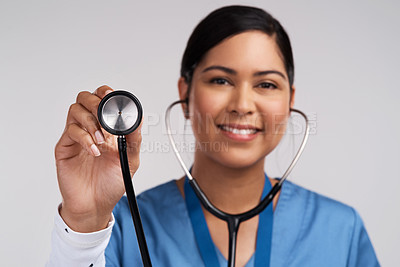 Buy stock photo Portrait of a young doctor using a stethoscope against a white background