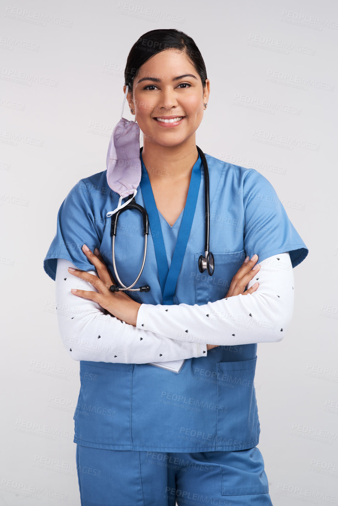 Buy stock photo Portrait of a young doctor folding her arms and wearing a stethoscope against a white background
