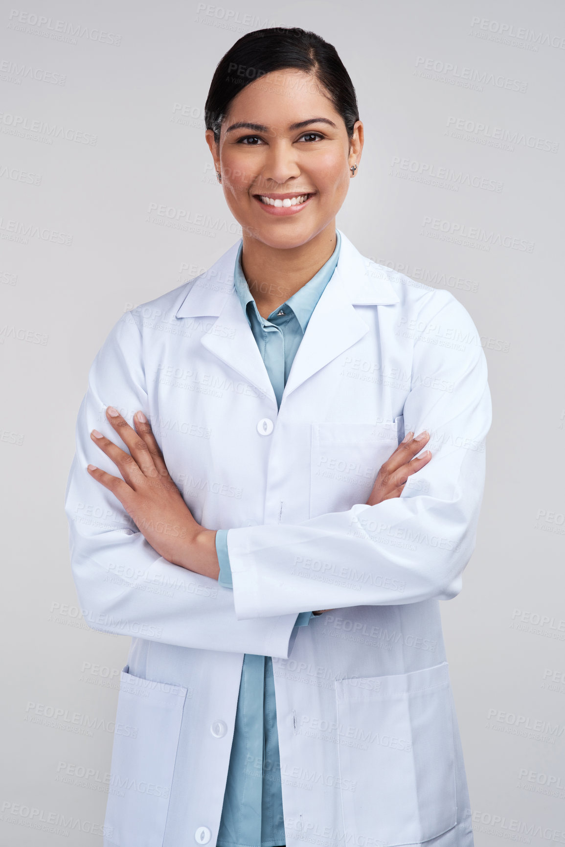 Buy stock photo Cropped portrait of an attractive young female scientist standing with her arms folded in studio against a grey background