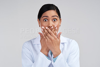 Buy stock photo Cropped portrait of an attractive young female scientist looking shocked in studio against a grey background