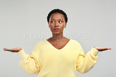 Buy stock photo Shot of a young woman holding up her hands while standing against a grey background
