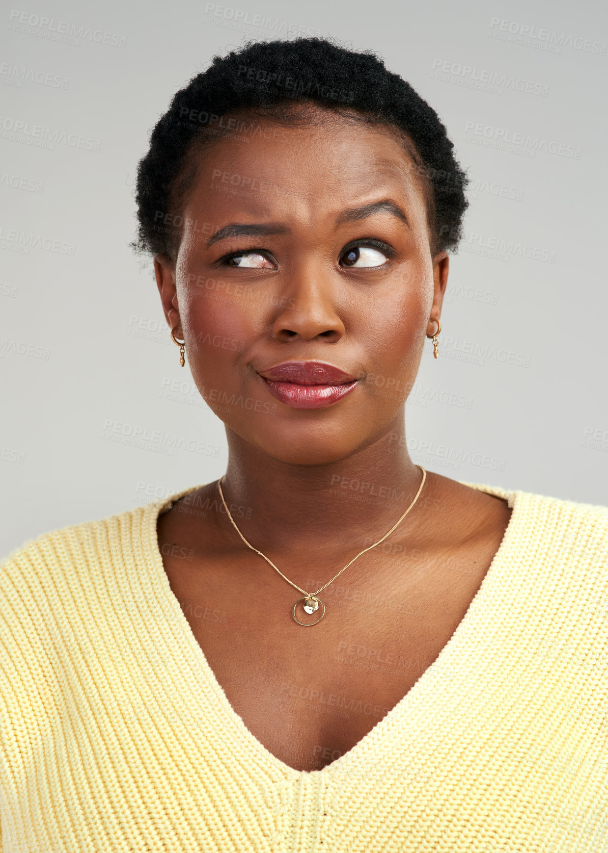 Buy stock photo Closeup shot of a beautiful young woman standing against a grey background