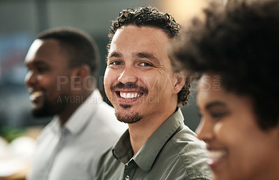 Buy stock photo Shot of a handsome young businessman standing in the office with his coworkers