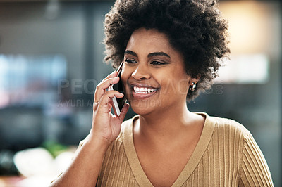 Buy stock photo Shot of an attractive young businesswoman standing in the office and using her cellphone