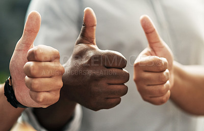 Buy stock photo Cropped shot of an unrecognizable group of businesspeople standing together and making a thumbs up gesture