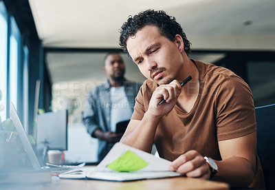 Buy stock photo Shot of a young businessman looking thoughtful in an office