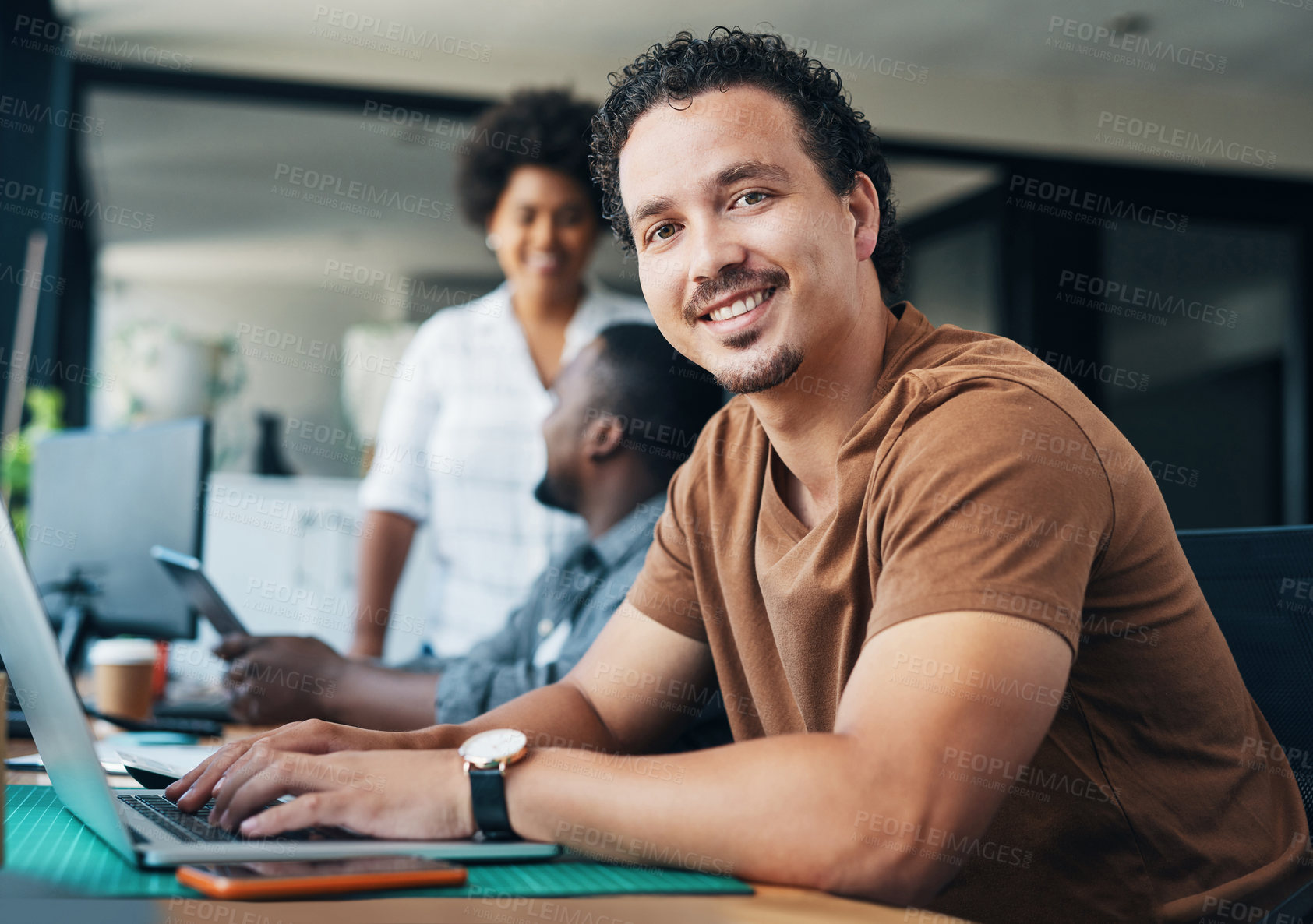 Buy stock photo Shot of a young businessman using a laptop in an office