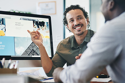 Buy stock photo Shot of two young businessmen having a discussion in an office