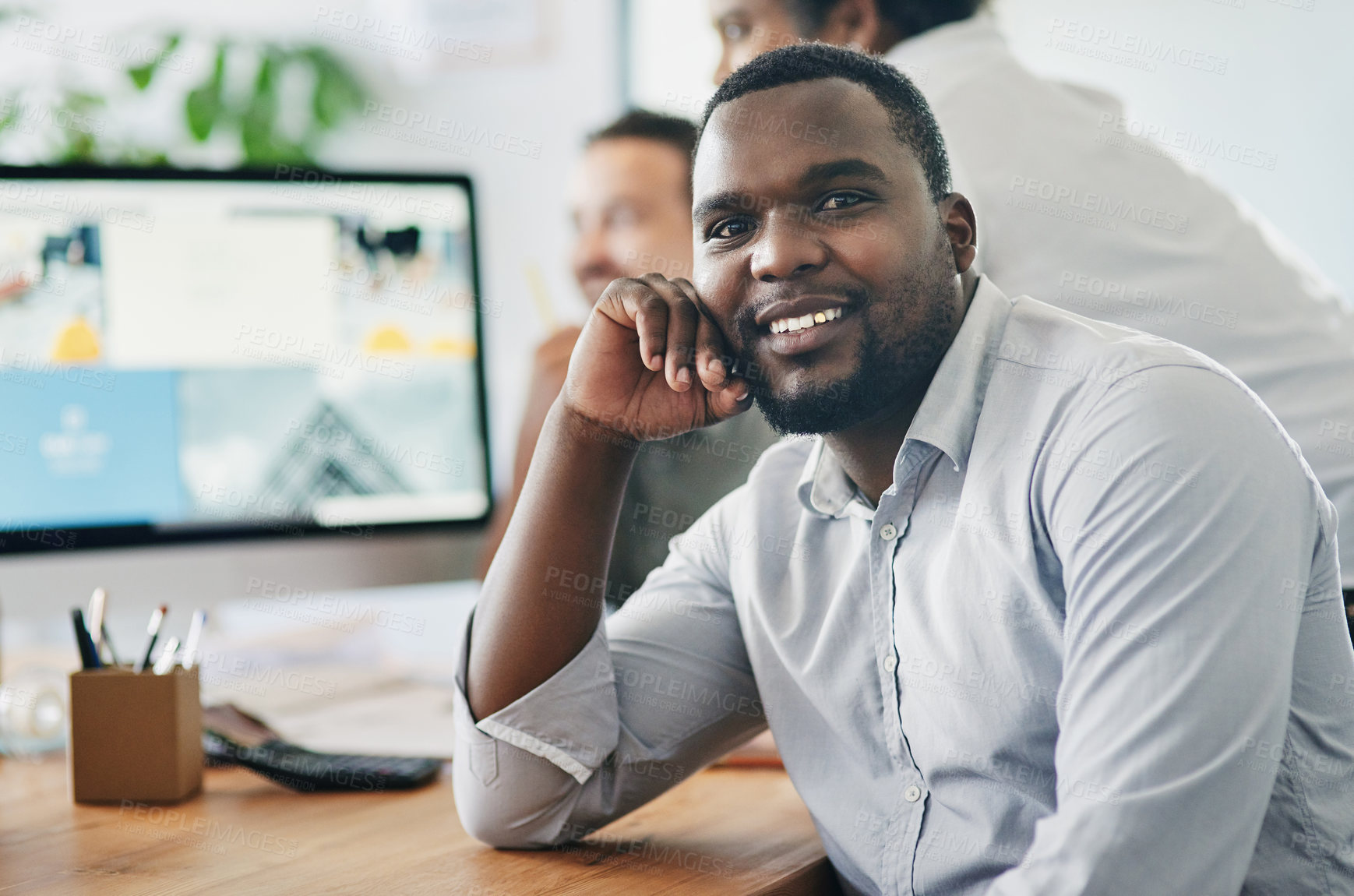 Buy stock photo Shot of a young businessman smiling in an office