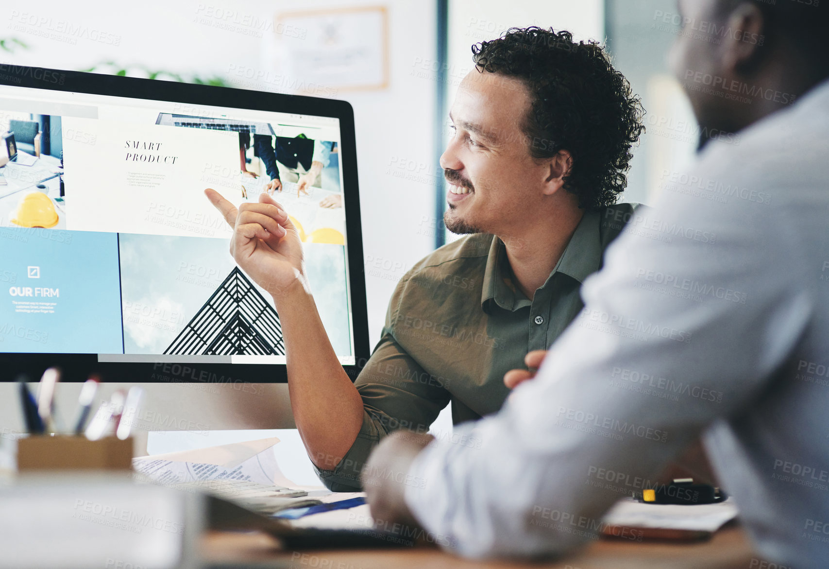 Buy stock photo Shot of two young businessmen having a discussion in an office