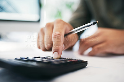 Buy stock photo Shot of an unrecognizable businessperson using a calculator in an office