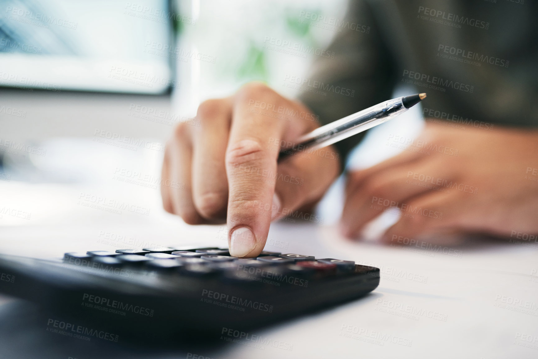 Buy stock photo Shot of an unrecognizable businessperson using a calculator in an office