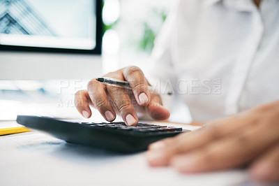 Buy stock photo Shot of an unrecognizable businessperson using a calculator in an office