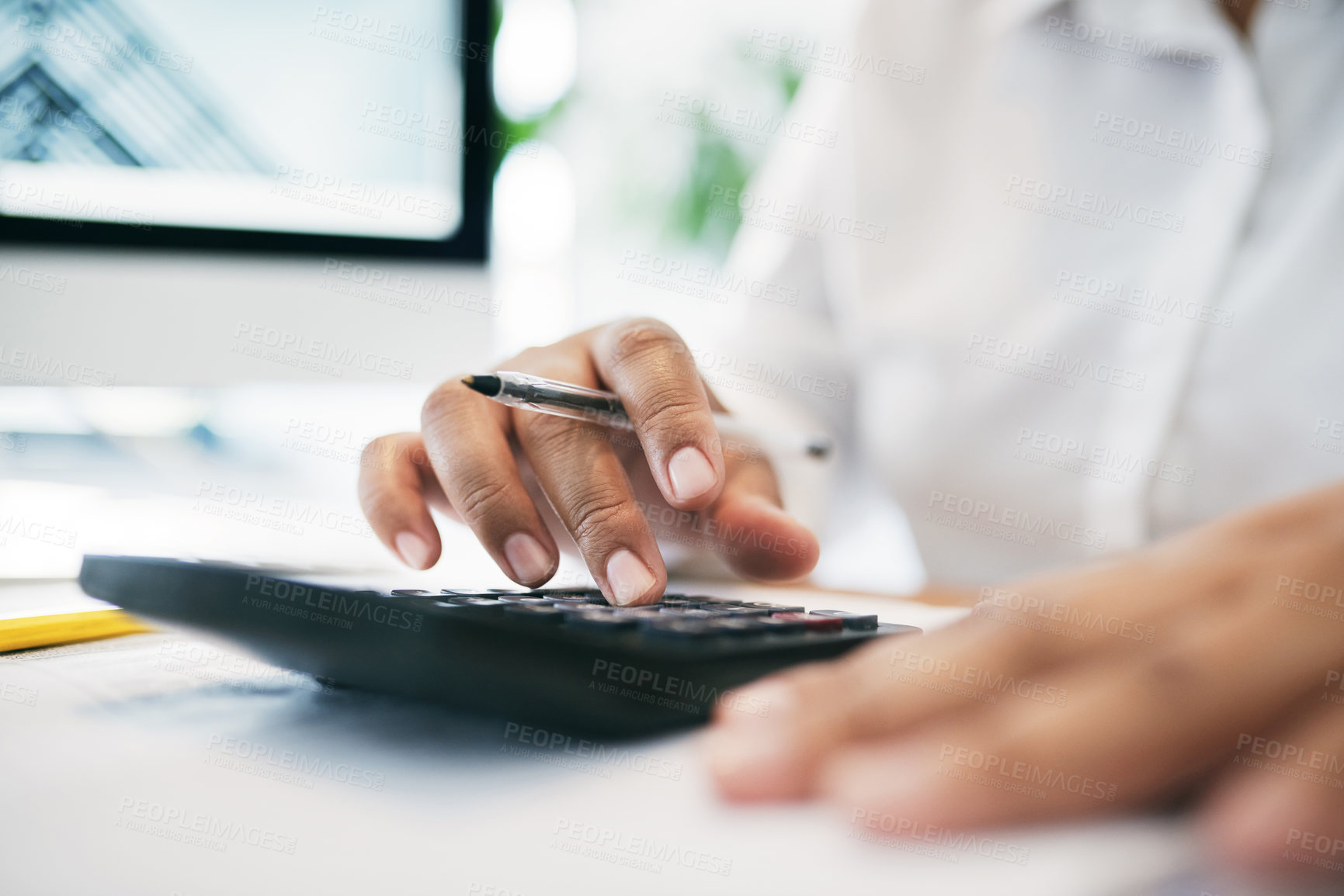 Buy stock photo Shot of an unrecognizable businessperson using a calculator in an office