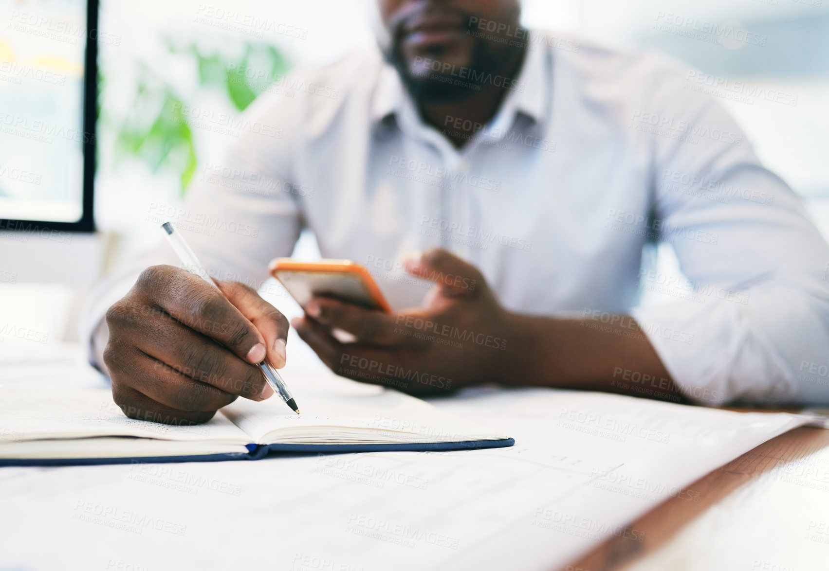 Buy stock photo Shot of an unrecognizable businessperson using a cellphone in an office