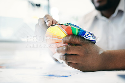 Buy stock photo Shot of an unrecognizable man holding various coloured  cards in an office