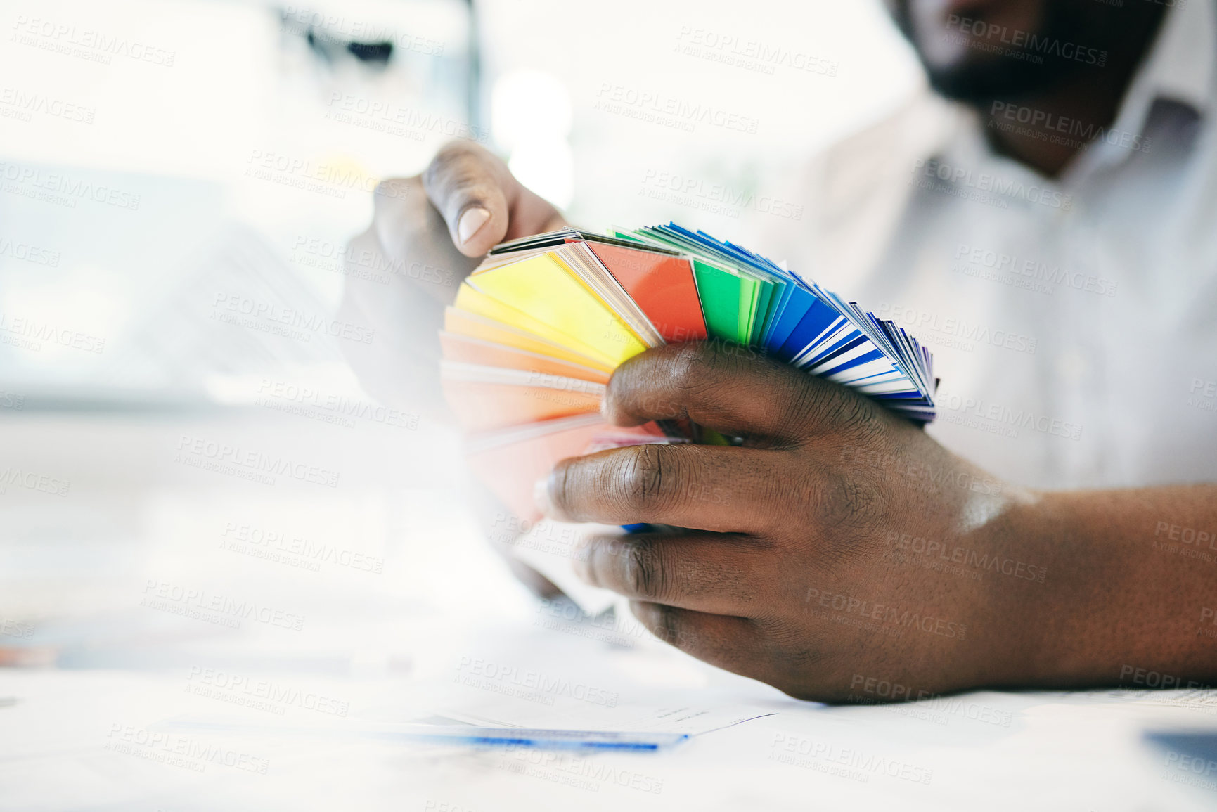 Buy stock photo Shot of an unrecognizable man holding various coloured  cards in an office