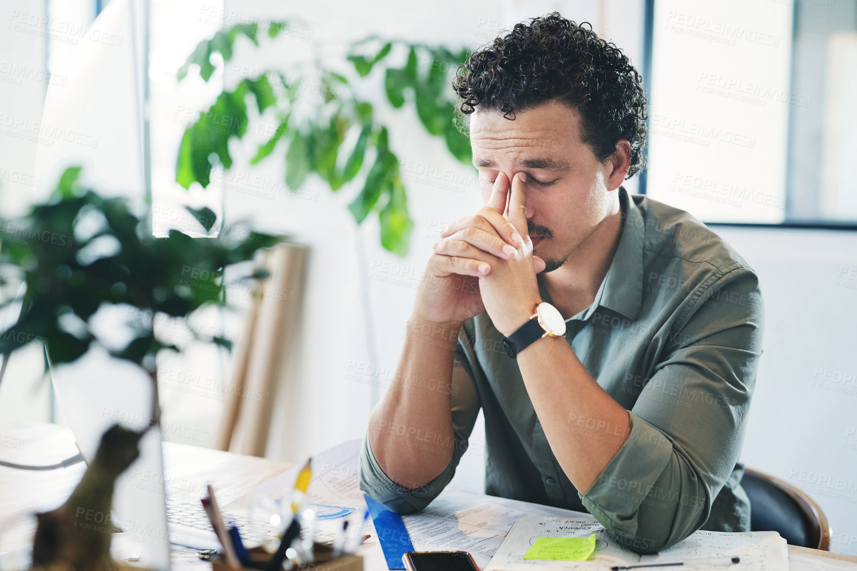 Buy stock photo Shot of a young businessman in pain in an office