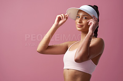 Buy stock photo Cropped portrait of an attractive and sporty young woman posing in studio against a pink background