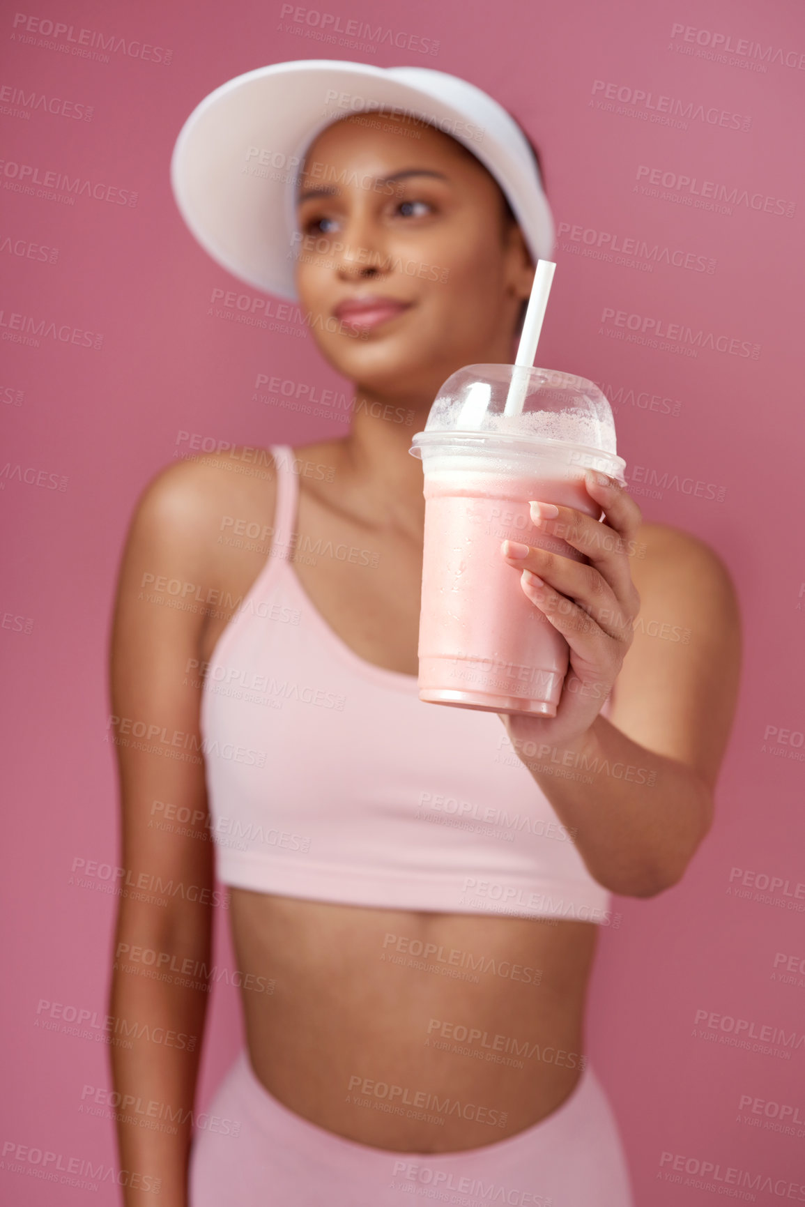 Buy stock photo Woman, smoothie and thinking in studio with hand for diet, fitness and drink for wellness. Athlete, female person and beverage for nutrition, health and detox or weight loss on pink background