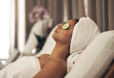 Buy stock photo Shot of a woman relaxing in a spa with cucumber slices on her eyes