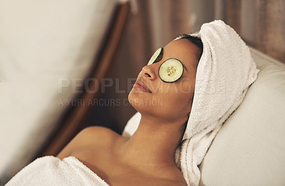 Buy stock photo Shot of a woman relaxing in a spa with cucumber slices on her eyes