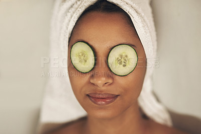 Buy stock photo Shot of a woman relaxing in a spa with cucumber slices on her eyes