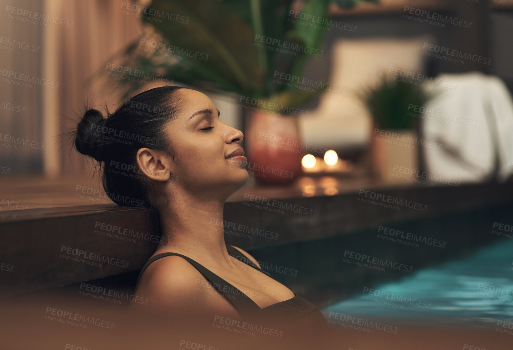 Buy stock photo Shot of a young woman relaxing in a pool at a spa