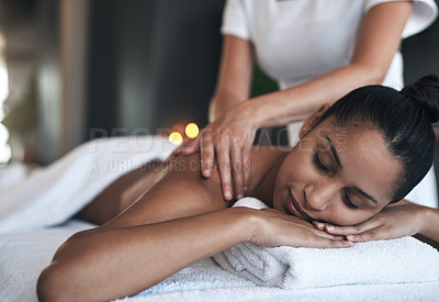 Buy stock photo Shot of a young woman getting a back massage at a spa