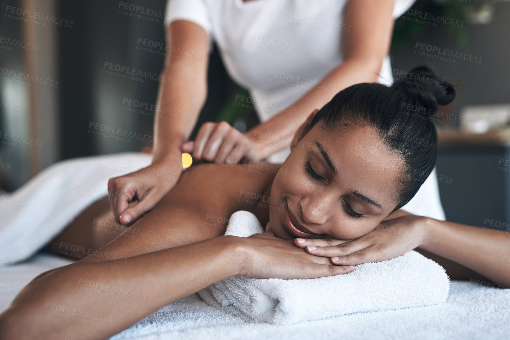 Buy stock photo Shot of a young woman getting a back massage at a spa