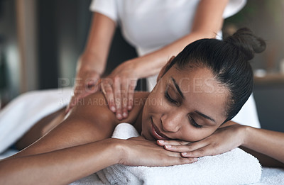 Buy stock photo Shot of a young woman getting a back massage at a spa