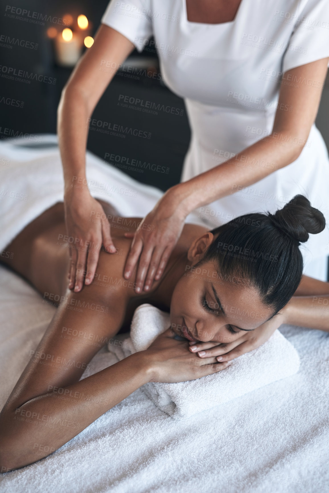 Buy stock photo Shot of a young woman getting a back massage at a spa