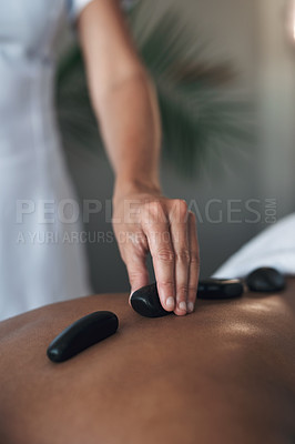 Buy stock photo Closeups shot of an unrecognisable woman getting a hot stone massage at a spa