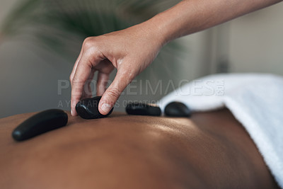 Buy stock photo Closeups shot of an unrecognisable woman getting a hot stone massage at a spa
